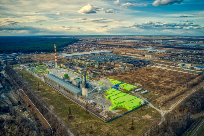 aerial view of green field and city during daytime